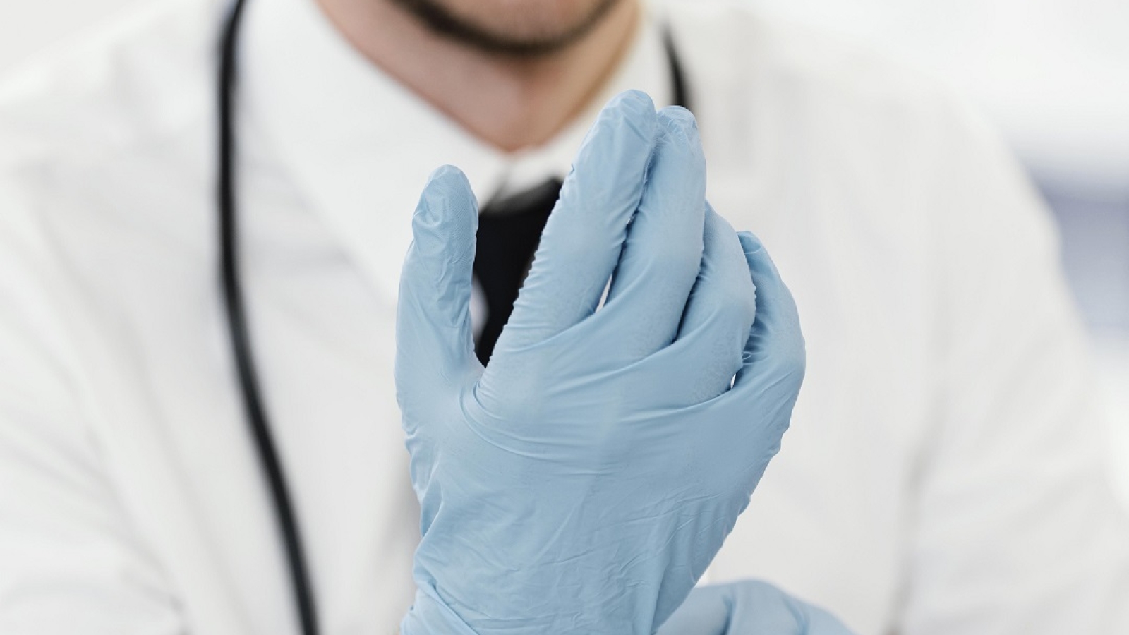 close-up-doctor-putting-gloves