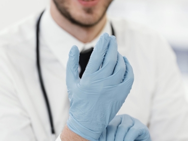close-up-doctor-putting-gloves