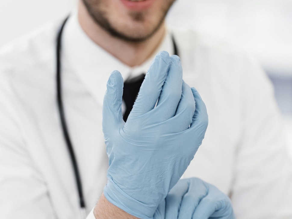 close-up-doctor-putting-gloves